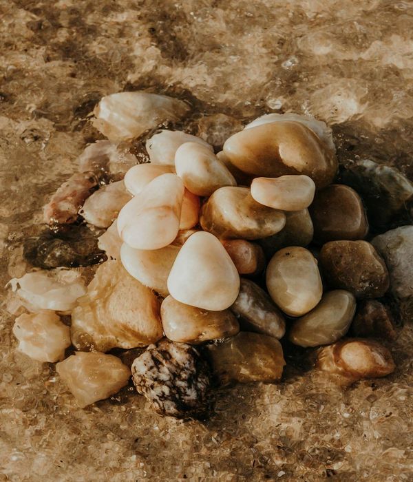 A balanced stack of stones on a tranquil beach.